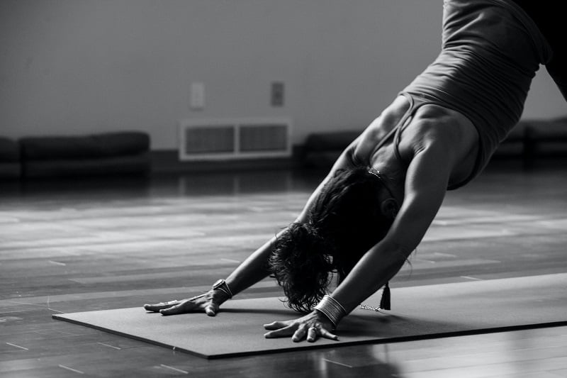 woman practicing yoga on a mat