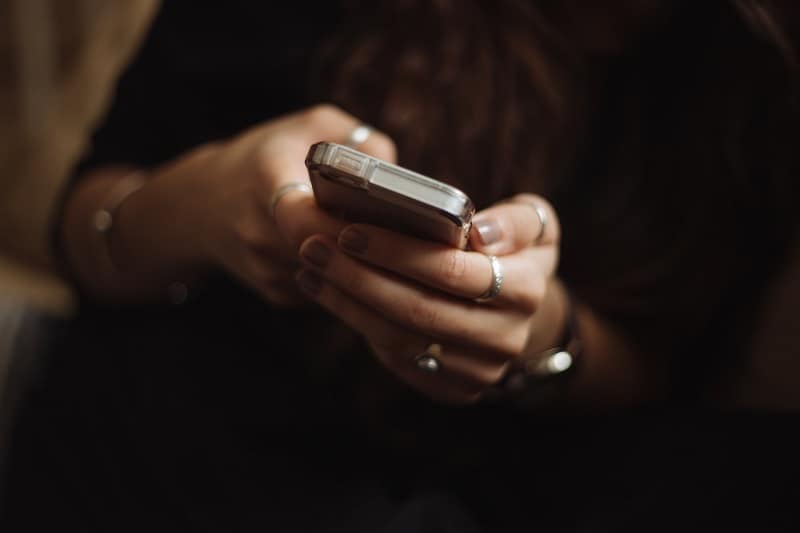 woman types on her smartphone