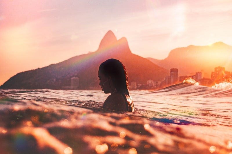 woman swimming alone surrounded by beautiful warm colors