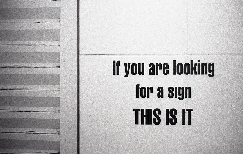 a door with a signs that says "if you are looking for a sign, this is it"