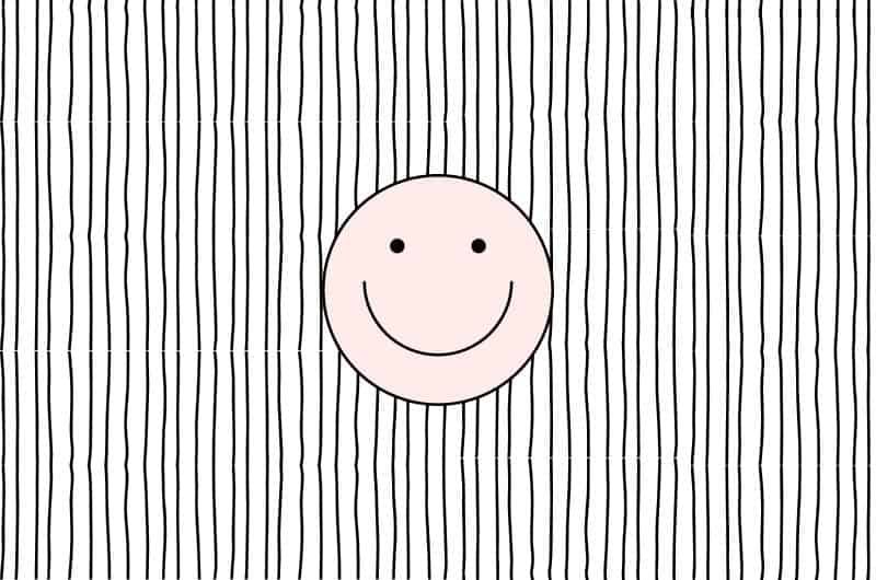 an illustration of a pink smiley face on a black and white striped background