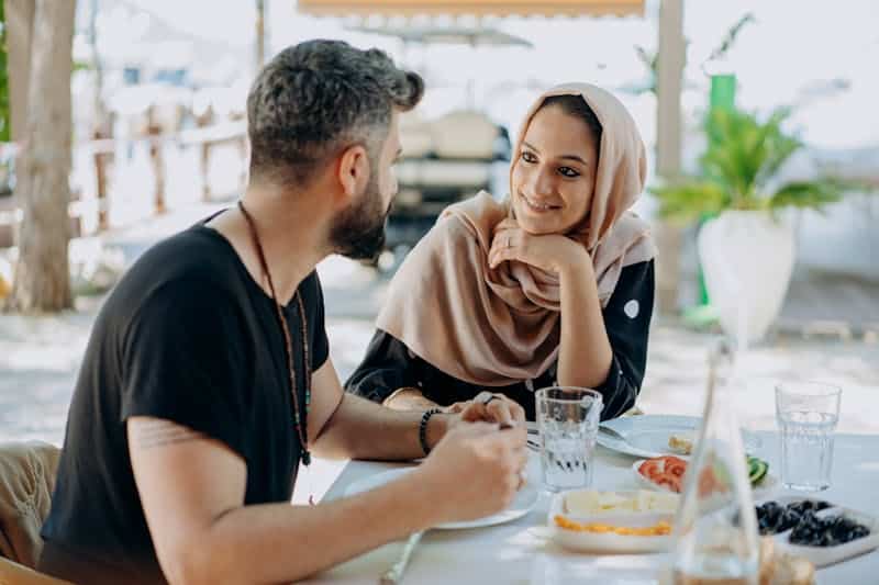 a young couple talks during lunch