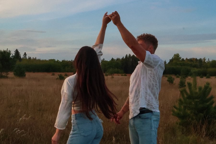 a couple dancing in a field