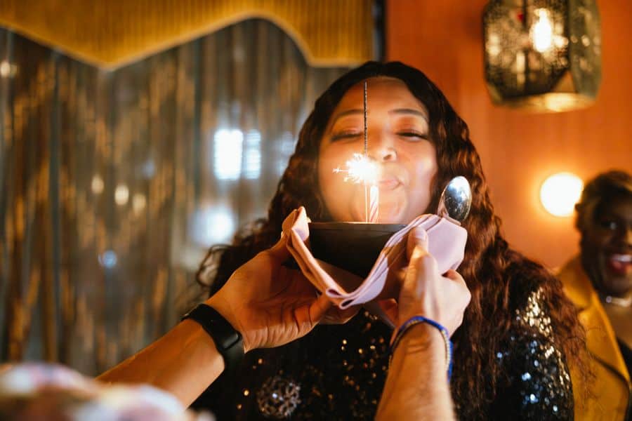 a woman blows candles on her birthday