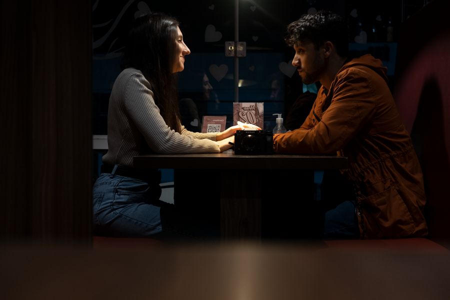 a man and woman on a date in a restaurant